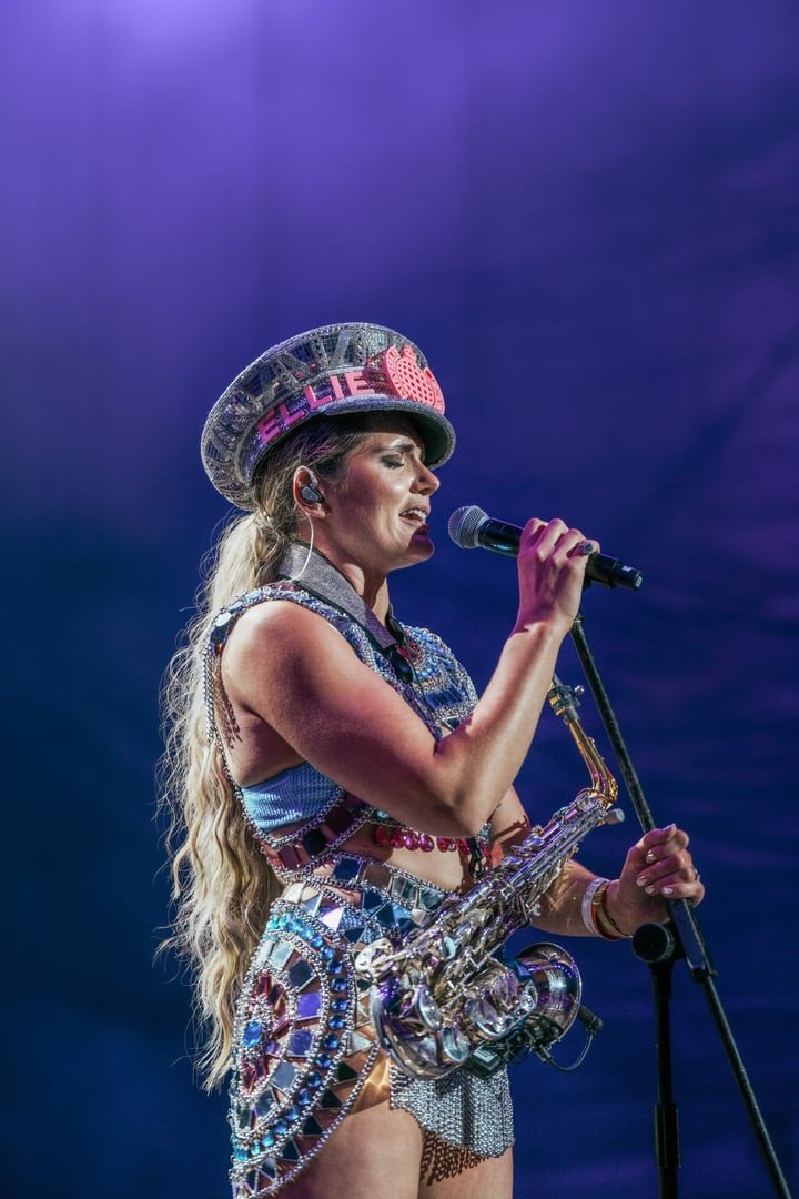 Ellie Sax singing with saxophone