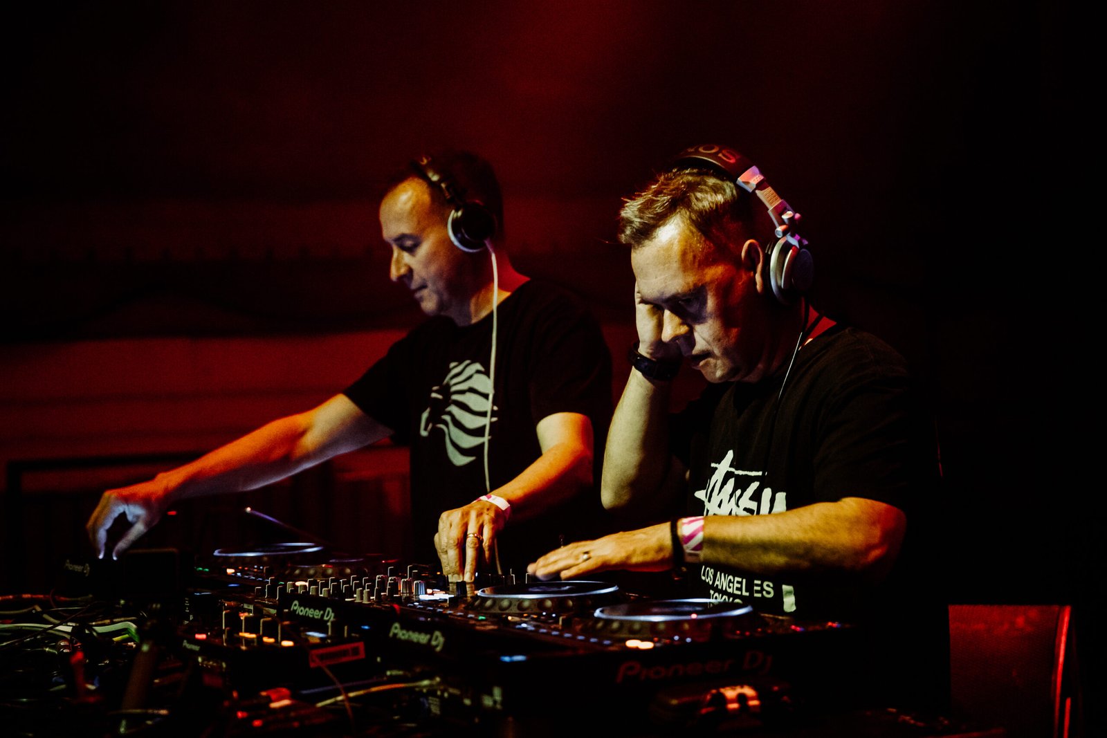 Utah Saints mixing at the decks in red club lighting